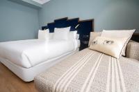 A bed or beds in a room at Soho Boutique Congreso