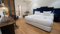 A bed or beds in a room at Soho Boutique Congreso