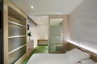 A bed or beds in a room at Ako Suite Hotel