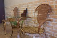 two chairs and a glass table in front of a brick wall at Gengmengyuan B&amp;B in Xikou