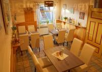 a dining room with a wooden table and chairs at Pension Post in Twiste