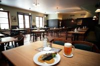 a plate of food on a table in a restaurant at Hotel Valcha in Prague