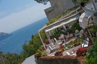 a building with chairs and flowers on the side of it at Casa Teresa in Positano