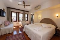 A bed or beds in a room at Villa Konak Hotel