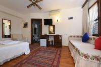 A bed or beds in a room at Villa Konak Hotel