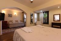 A bed or beds in a room at Villa Konak Hotel