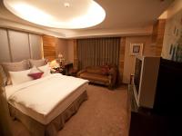 Tempat tidur dalam kamar di Taipei Lotty Hotel