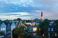 a view of a city with houses and a church at Hotel Espresso in Amsterdam