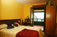 Postel nebo postele na pokoji v ubytování Hotel Restaurante Canero
