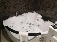 a white bath tub in a bathroom with a sink at Maximus Hotel Byblos in Jbeil