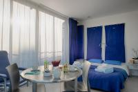 a bedroom with a bed and a table and chairs at Les Thermes in Dax