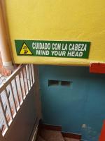 a sign on the side of a building at Hotel Posada Tayazal in Flores