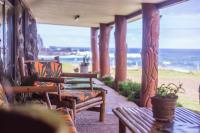 a porch with chairs and a view of the ocean at Cabañas &amp; Hostal Tojika in Hanga Roa