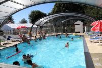 a group of people swimming in a swimming pool at Camping le Clos de Balleroy in Balleroy