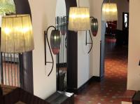 two lights on a wall next to a hallway at Hôtel et Résidence de Chiberta et du Golf in Anglet