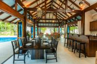an open dining room with a table and chairs at Koh Jum Beach Villas "A member of Secret Retreats" in Ko Jum