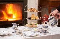 a table with a tea party with a cake and tea cups at PortoBay Serra Golf in Santo António da Serra