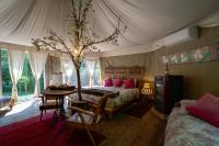 a bedroom with a bed and a tree in it at Glamping Canonici di San Marco in Mirano