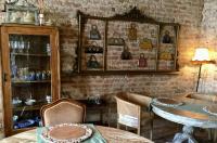 a room with a table and chairs and a wall with items at Glamping Canonici di San Marco in Mirano
