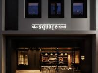 una tienda frente a un hotel cuadrado con mesas y sillas en the square hotel GINZA, en Tokio