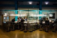 a group of people sitting at a bar at Hotel Alte Werft in Papenburg