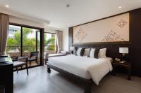 a bedroom with a large bed and a large window at Krabi Heritage Hotel in Ao Nang Beach