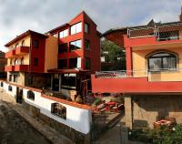a group of buildings with red and yellow at Armira Family Hotel in Ivaylovgrad