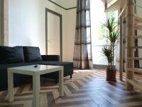 a living room with a couch and a table at Pavillon Kalensa in Vals-les-Bains