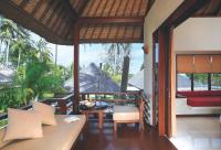 a balcony of a house with a table and chairs at Qunci Villas Resort in Senggigi