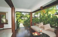 a living room with a couch and a table at Qunci Villas Resort in Senggigi