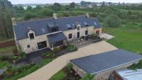 an aerial view of a house with solar panels on it at Kervran in Plouhinec