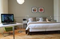 a bedroom with a bed and a desk with a laptop at Villa Élyane in Colmar