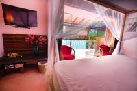 a bedroom with a bed and a desk and a television at Dickman Resort "The Boutique Hotel" in Negombo