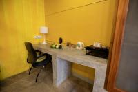a desk in a room with a chair and yellow walls at Dickman Resort "The Boutique Hotel" in Negombo