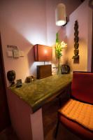 a room with a desk with a vase of flowers and a chair at Dickman Resort "The Boutique Hotel" in Negombo