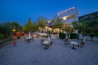 a restaurant with tables and chairs in front of a building at Plakias Bay Hotel in Plakias