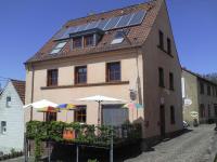 a house with solar panels on top of it at Gästehaus &#39;Alte Bäckerei&#39; Kaffeehaus in Großbundenbach
