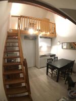 a kitchen and a dining room with a staircase and a table at Appartement Sainte Marie de Campan - Résidence le Vieux Village in Sainte-Marie-de-Campan