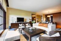 a living room with a couch and a table at Capella Singapore in Singapore