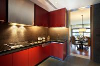 a kitchen with red cabinets and a dining room at Capella Singapore in Singapore