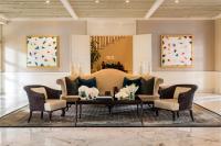 a living room with a couch and two chairs and a table at Capella Singapore in Singapore