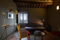 a living room with a couch and a table at Palazzetto Rosso - Art Hotel in Siena