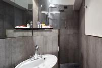 a bathroom with a sink and a mirror at Palazzetto Rosso - Art Hotel in Siena