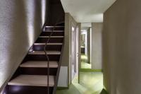 a spiral staircase in a room with a hallway at Palazzetto Rosso - Art Hotel in Siena