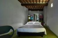 a bedroom with a large bed in a room at Palazzetto Rosso - Art Hotel in Siena