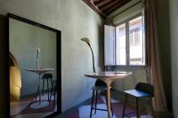 a room with a table and chairs and a mirror at Palazzetto Rosso - Art Hotel in Siena
