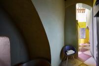 a hallway with a blue chair in a room at Palazzetto Rosso - Art Hotel in Siena
