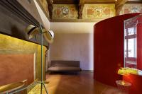 a living room with a couch and a chair at Palazzetto Rosso - Art Hotel in Siena