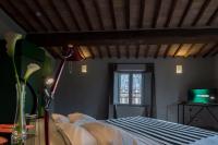 a bedroom with a bed and a window at Palazzetto Rosso - Art Hotel in Siena