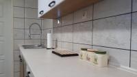 A kitchen or kitchenette at Csóka Apartman Pápa